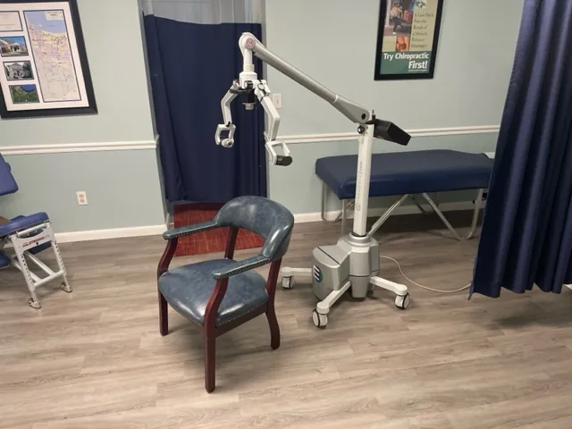 Chiropractic treatment room with cervical traction device and examination chair